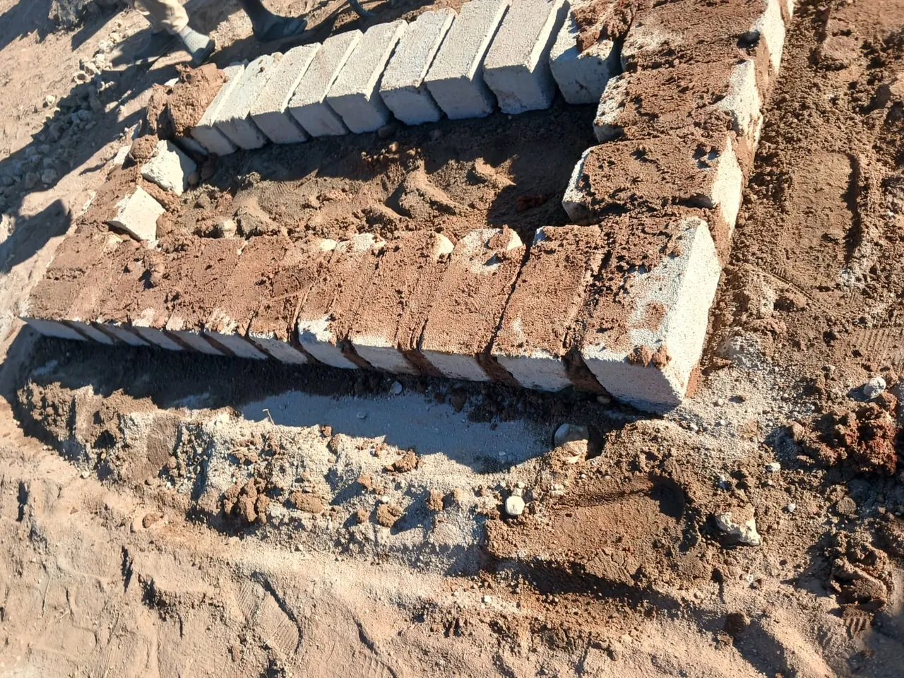 Brick foundation and mortar being prepared for a memorial