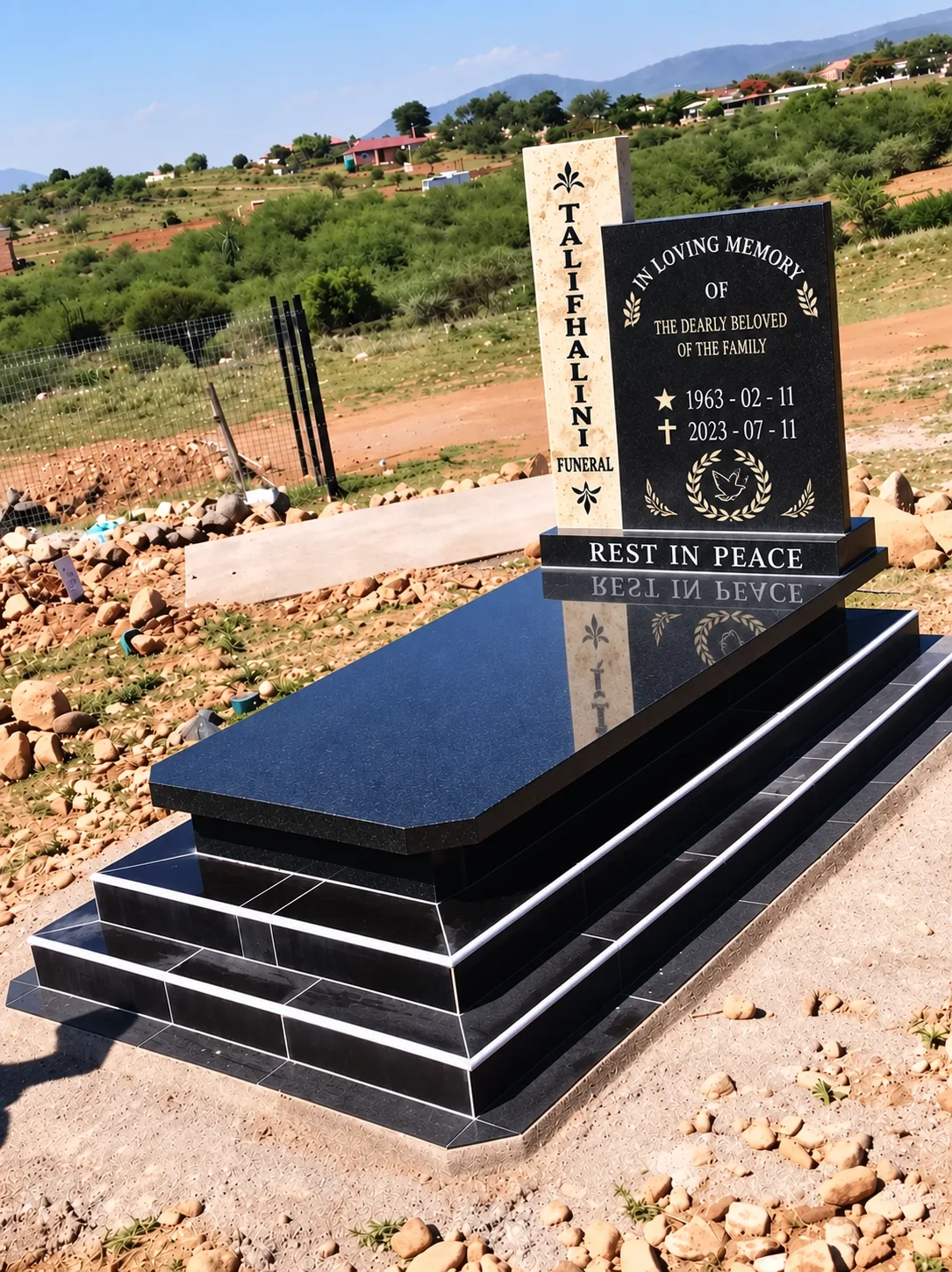 Completed engraved granite memorial with a stone-clad base